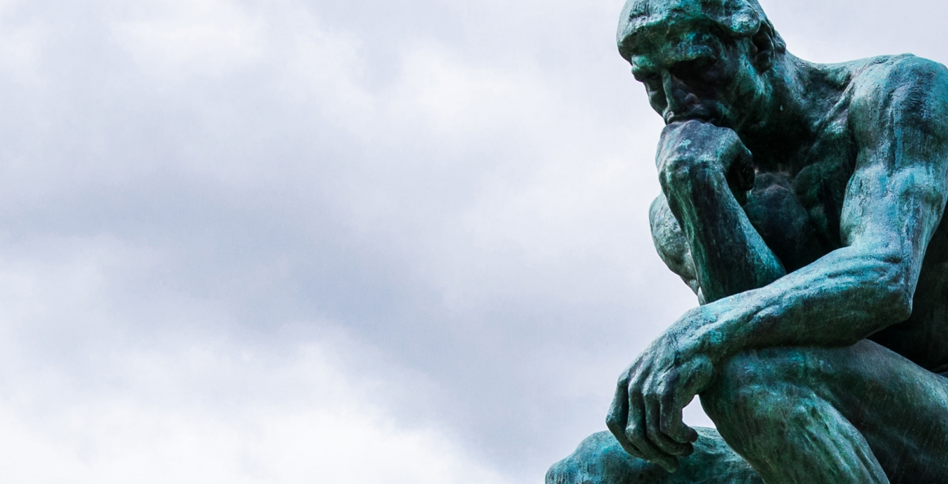 "The Thinker" sculpture against cloudy sky