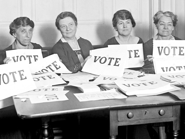 Women holding vote signs
