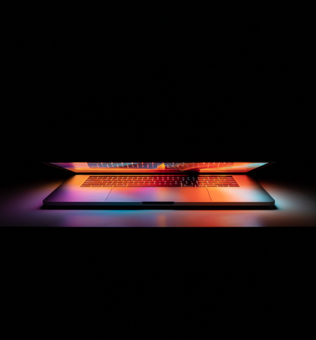 laptop glowing in dark room