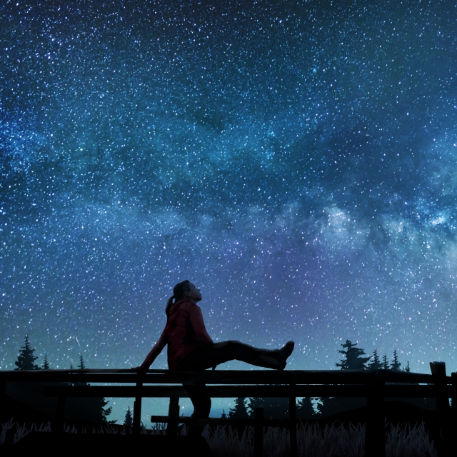 A women sitting and looking at the starry sky 