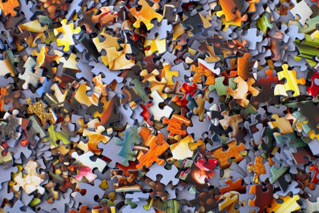 Overhead view of scattered puzzle pieces