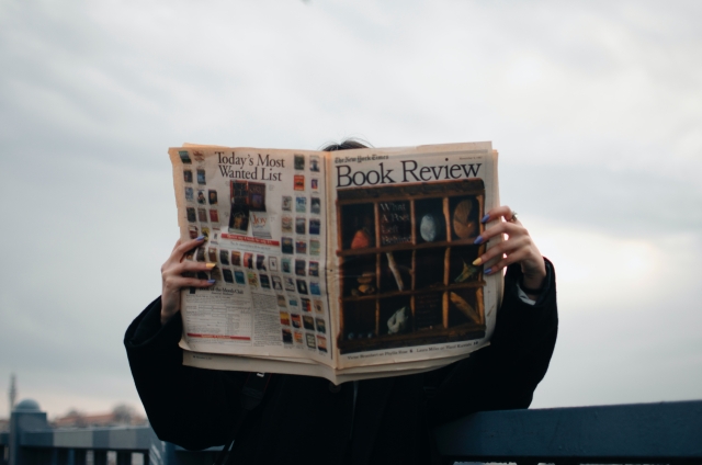 person holding book review