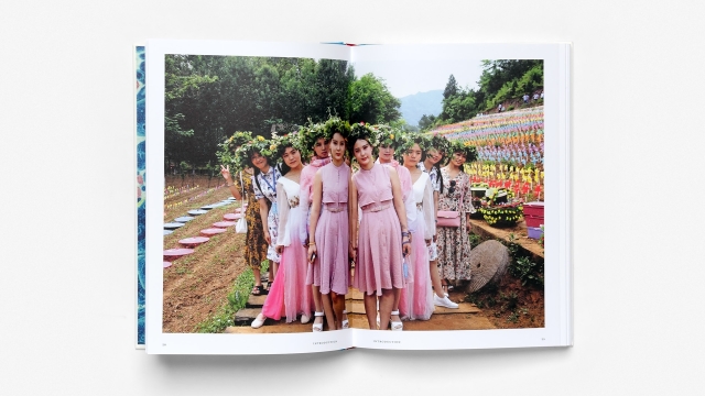Twinkind by William Viney, 2 page spread, Asian women in colorful dress in garden