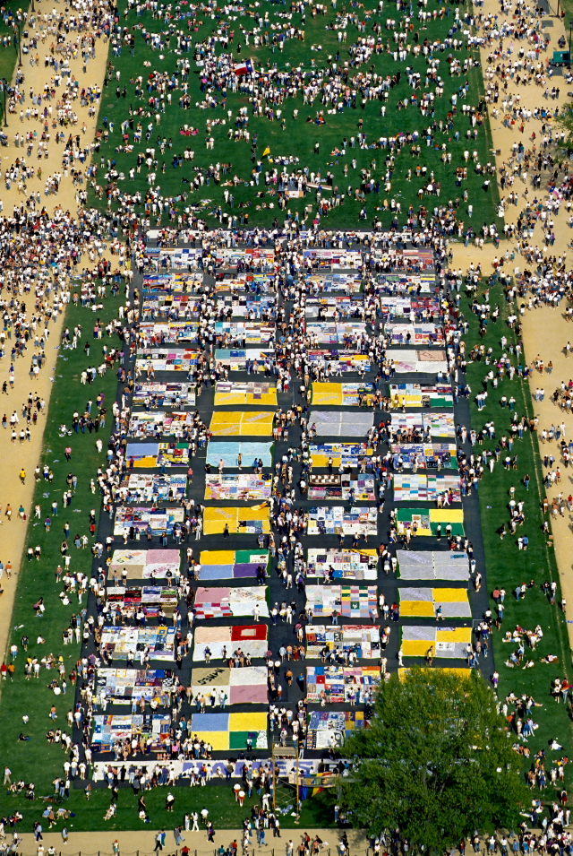 Overhead view of AIDS memorial quilt and crowd.