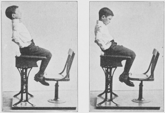 2 b&w photos of white boy seated at desk. 1st photo he is demonstrating a posture-correcting excercise, in 2nd he is slouching.