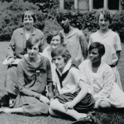 Female students sit on lawn of college campus