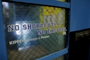 sign on window reading "No shortcuts, no excuses."
