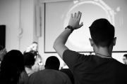 a student raising their hand in a classroom