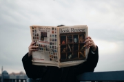 person holding book review