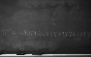 A photograph of a chalkboard with the numbers of Pi written across it