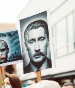A protest sign showing a portrait of Vladimir Putin edited to look like Joseph Stalin
