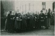 Group of girls and women standing on street.